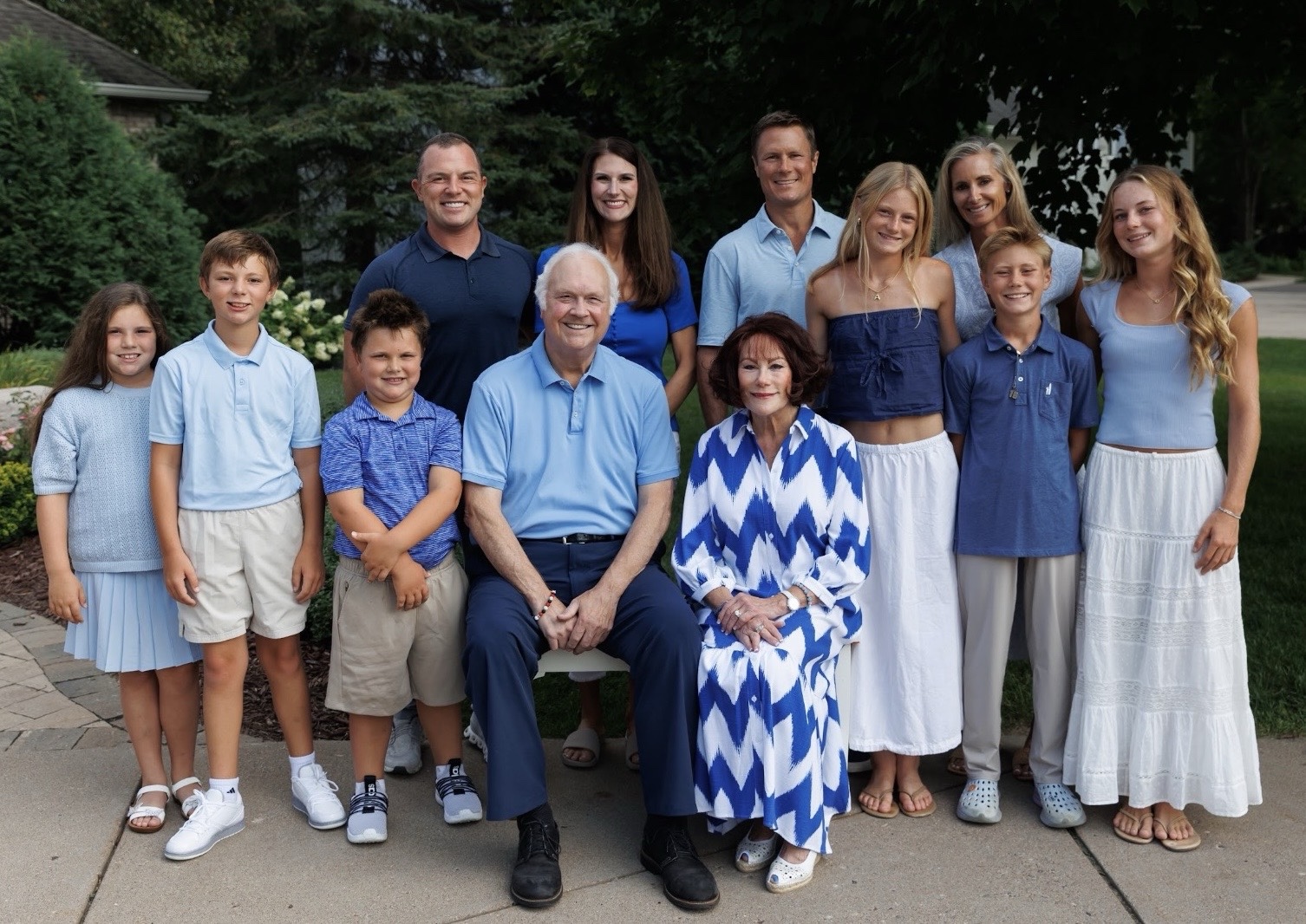 Phil Paquette with his wife and family gathered outdoors